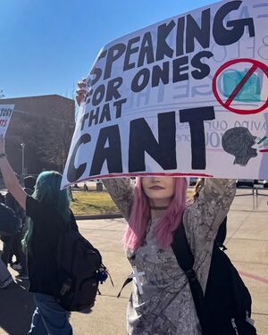 Student Holds A Protest Sign.jpg